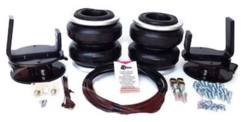 Air suspension kit components laid out: four air springs, brackets, hoses, bolts, and hardware