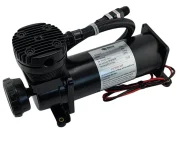 PX06 compressor - Boss Air Suspension Black portable electric air compressor with a cylindrical tank, finned motor housing, and attached hose and fittings.