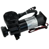 Black portable electric air compressor with a cylindrical tank, finned motor housing, and attached hose and fittings.
