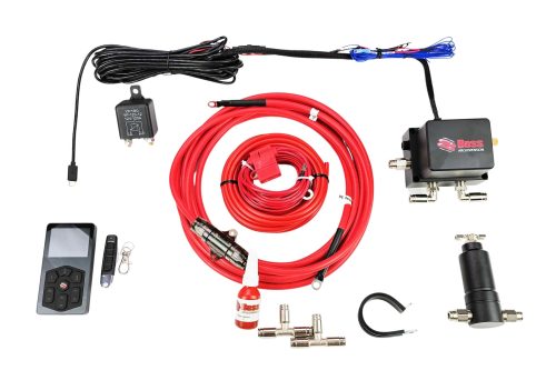 Automotive air suspension kit parts laid out: red air hoses, control module, remote, and fittings on a white background. contrasty hardware included.